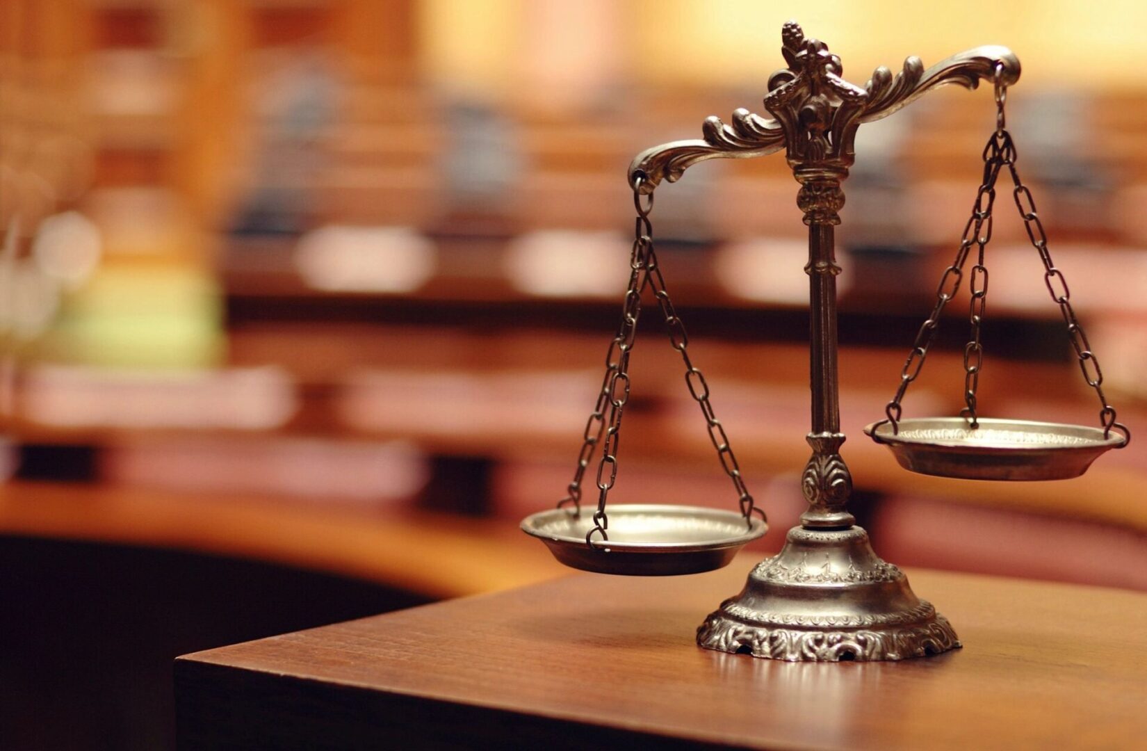 A close up of the scales of justice on top of a table